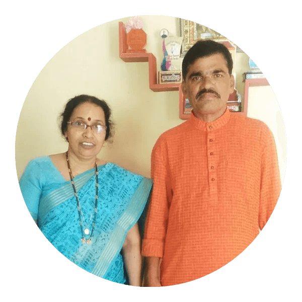 Parents hugging their child surrounded by books