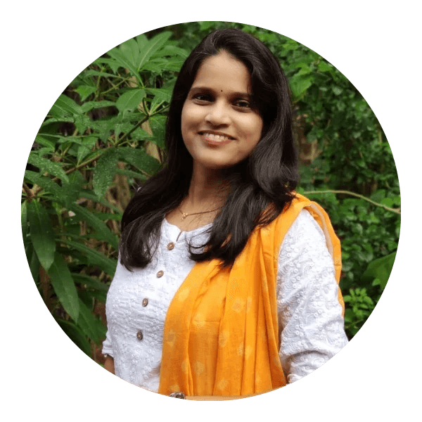 Vaibhavi Raorane-Pol smiling with a stack of children books