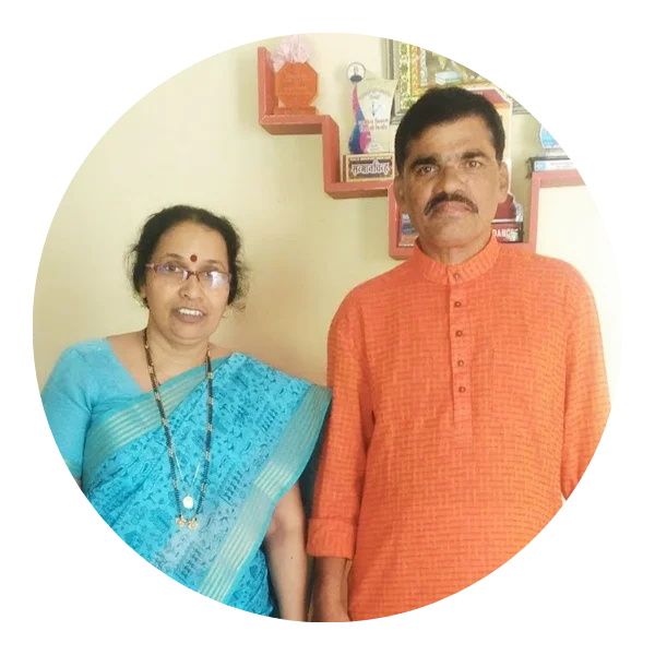 Parents hugging their child surrounded by books